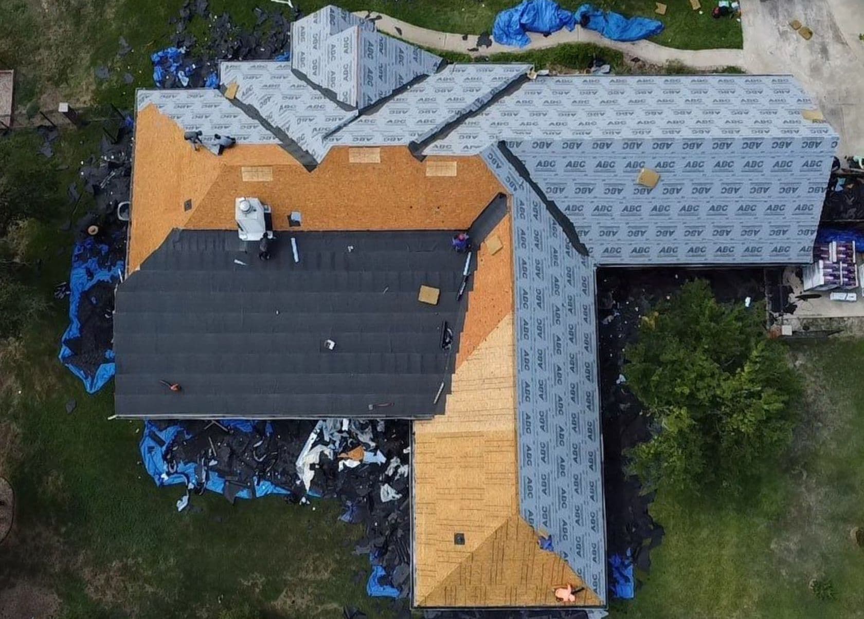 Aerial view of roofing materials being installed on a home